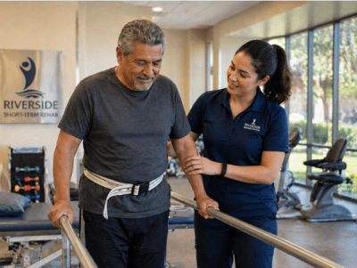 A therapist assists a man in rehabilitation exercises.