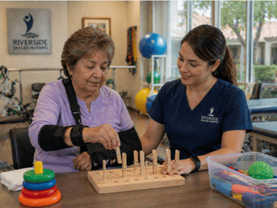 Staff assisting resident with a sensory activity.