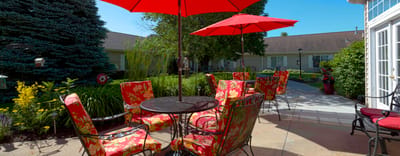 Outdoor seating area with colorful umbrellas and flowers