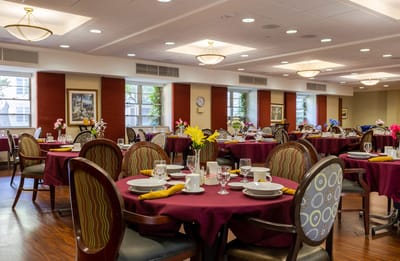 Dining room set for a meal with flowers and tableware