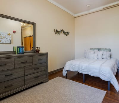 Bright interior of a private resident room with a bed