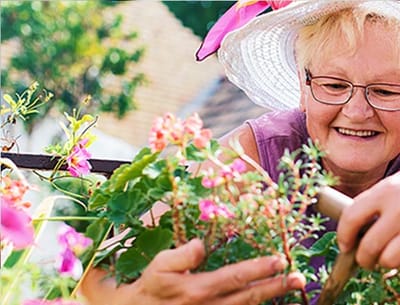 Resident gardening in a vibrant outdoor space