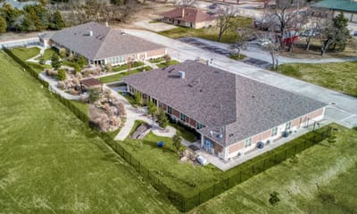 Aerial view of AvilaCare Assisted Living with landscaped garden