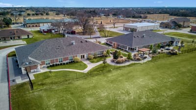 Aerial view of a senior living facility with gardens