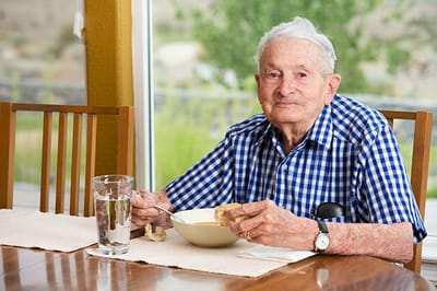 Senior man enjoying a meal in a dining area