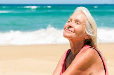 Older woman enjoying the beach on a sunny day