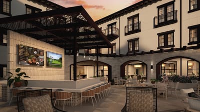 Outdoor dining area with seating and a menu board