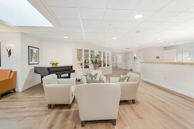 Interior view of a common area with comfortable seating and a piano