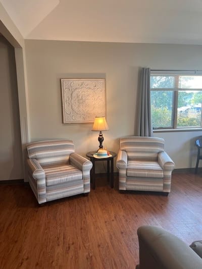 Cozy seating area with two armchairs and a lamp