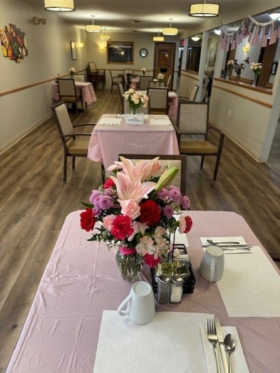 Dining area with floral centerpieces and set tables