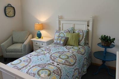 Cozy bedroom setup with decorative bedding and furniture