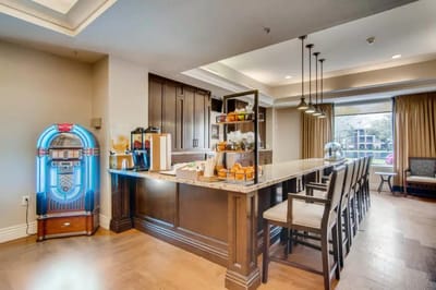 Bright communal kitchen area with counter and seating