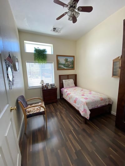 Private resident room with bed and chair