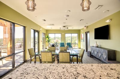 Bright common area with seating and large windows