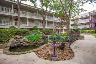 Well-maintained outdoor area with foliage and a water feature