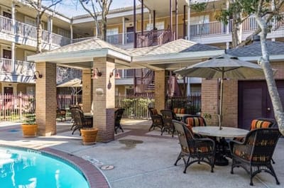 Outdoor seating area with tables and umbrella