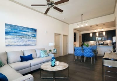 Bright and modern living room area with kitchen in view