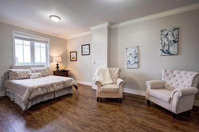 Well-furnished resident room with cozy seating