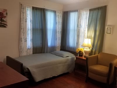 Cozy resident room with a bed and lamp
