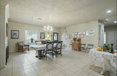 Common area with tables and chairs in a bright setting