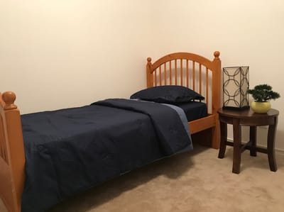 A private resident room with a bed and table