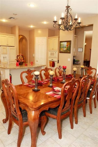 Elegant dining area with a large wooden table and chandelier