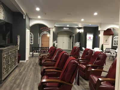 Interior common area with red chairs and a clock