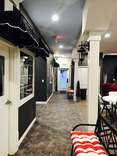 Interior corridor of a senior living facility with fitness center signage