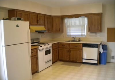 Bright kitchen area with wooden cabinets and appliances