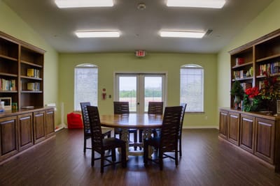 Common area with a round table and bookshelves