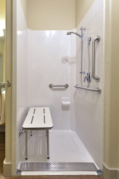 Accessible shower with grab bars and bench