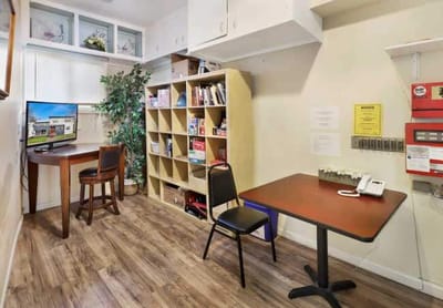 Interior view of a small room with a desk and shelves