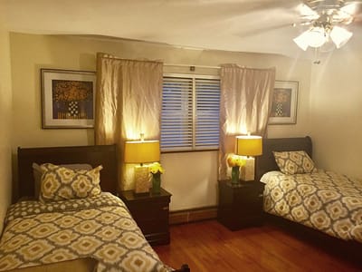 Cozy shared bedroom with two beds and lamps