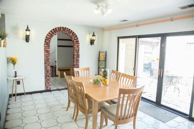Bright common area with dining table and archway