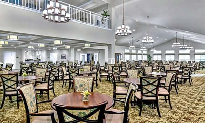 Dining room setup with tables and floral centerpieces