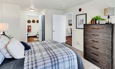 Bright, well-furnished resident bedroom showcasing interior design