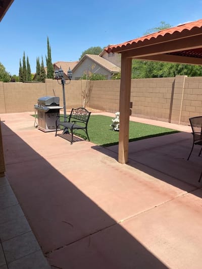 Patio area with seating and grill in an outdoor space