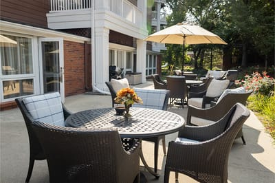 Outdoor patio seating area with tables and umbrellas