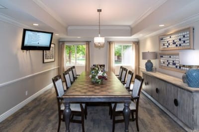 Bright common area with a large dining table and decor