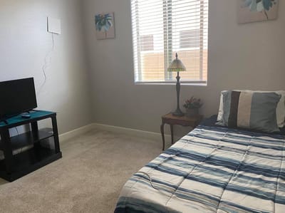 Cozy resident room with bed and TV