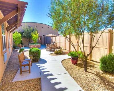 A serene garden area with seating and pathways