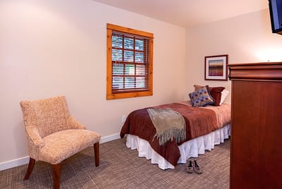 Comfortable private room with a bed and chair