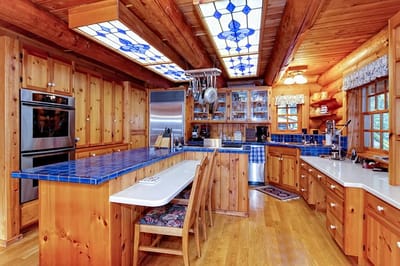 Spacious wooden kitchen with bright blue countertops