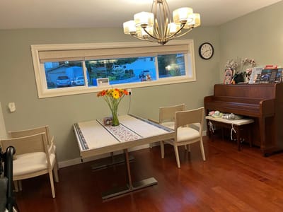 Dining area with a table, chairs, and a piano