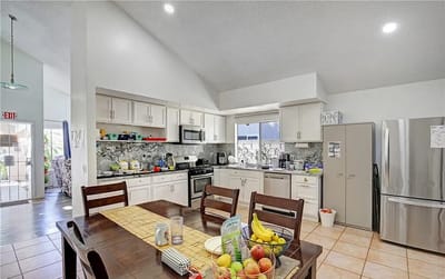 Bright kitchen area with dining table and fruit bowls