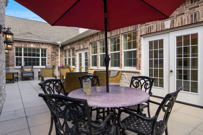 Outdoor patio area with seating and umbrella