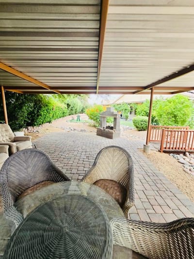 Outdoor seating area with greenery in the background
