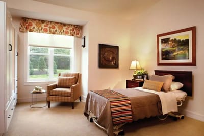 Cozy resident room with bed and armchair