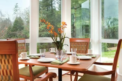 A dining table set with flowers and tea service