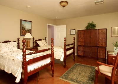 A cozy shared resident room with two beds and furniture